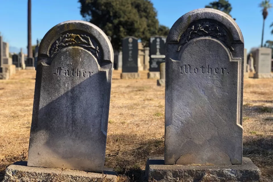 Cement gravestones reading Father and Mother